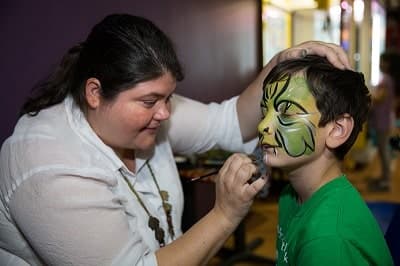 Dory Fostok face painting with a smile